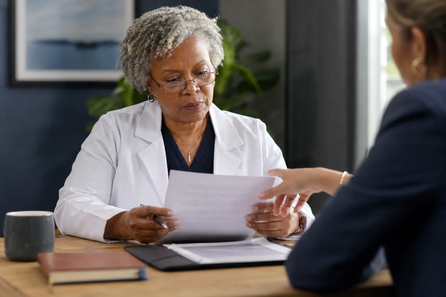 Physician reviewing a contract with a professional advisor